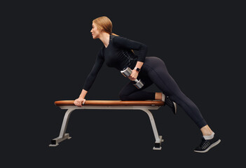 Obraz premium Beautiful young woman trains deltoid on bench in gym isolated on black