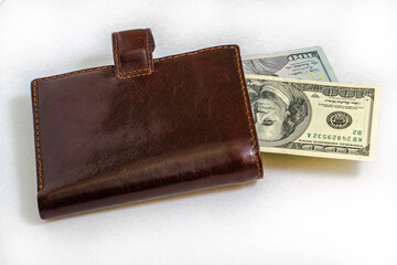 hundred-dollar bills sticking out of a leather purse