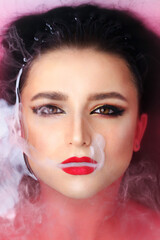Beautiful young brunette model with bright make-up in bath, water