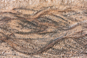 Background from sand. Abstract drawing, which left the water on the sand.
