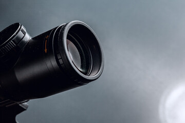 Black rifle optical sight on black background