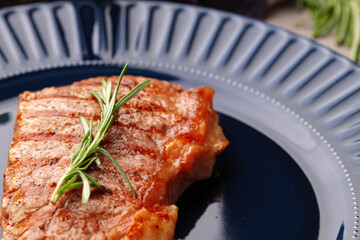 Grilled beef steak served on blue plate