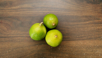 Fresh local calamansi or limau kasturi with wooden background
