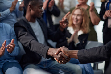 Glad to work with you. Young modern men in smart casual wear shaking hands