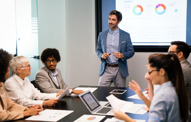 Happy diverse business colleagues meeting, working in modern office