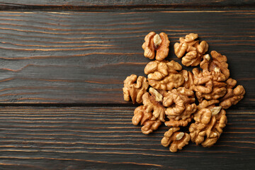 Heap of tasty walnuts on wooden background
