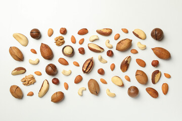 Different tasty nuts on white background, top view