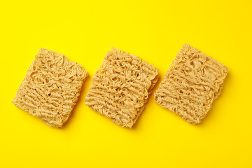Flat lay with instant noodles on yellow background
