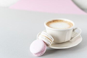 Cup of coffee, pasta for the cake on a gray and pink background. Copy space.