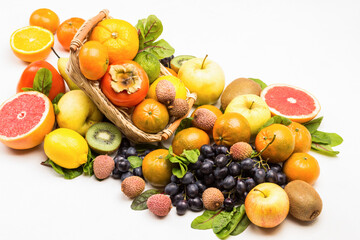 Naklejka na ściany i meble Set of varied, multicolored exotic fruits. Mandarins, grapefruit, lychee, kiwi and grapes with chard leaves