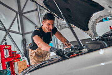 Fototapeta na wymiar Portrait of a mechanic at work in his garage.