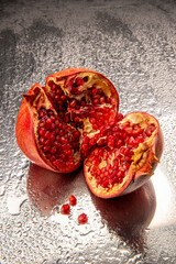 Pomegranate fruit on metal water background