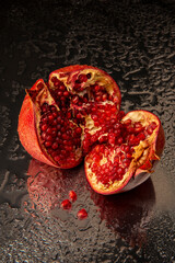 Pomegranate fruit on metal water background