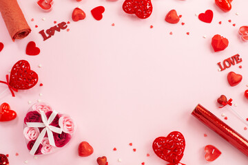 Red hearts, gifts and candles on a festive pink background.