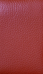 Texture of crimson red colored cow leather surface for abstract background