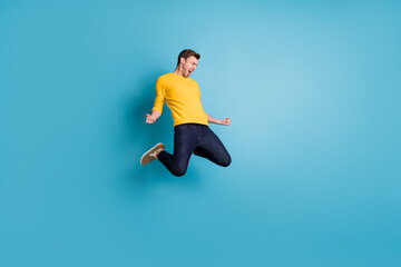 Fototapeta na wymiar Full length body size view of nice cool crazy cheerful guy jumping having fun celebrating isolated over bright blue color background