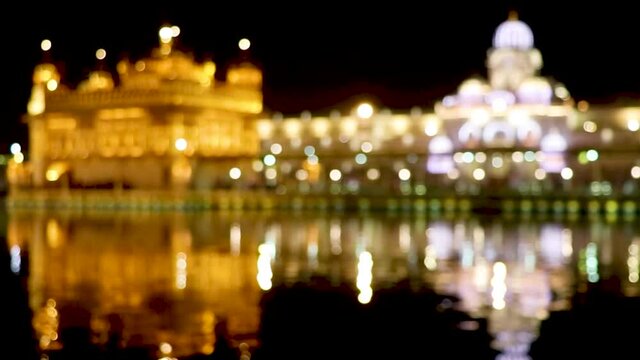 Amritsar, Punjab, India - January 06, 2019 : golden temple with reflection in the water at night