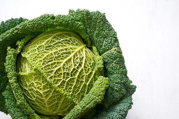 Fresh organic savoy cabbage head isolated on a white background
