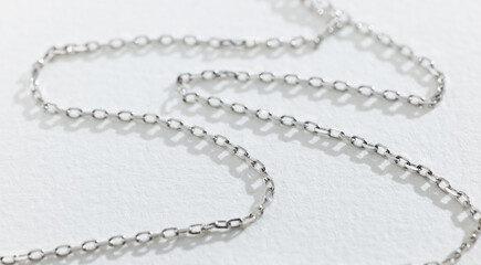 silver chain on white paper background
