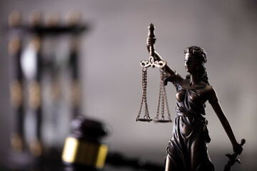 Law and justice concept. Law symbols composition: judge’s gavel and Themis  statue.