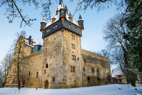 German fairytale castle in winter landscape. Castle Romrod in Hesse, Vogelsberg, Germany. Beautiful view on castle.