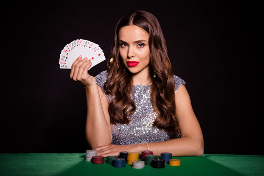 Photo of pretty lady sit poker table demonstrate fan cards wear glossy dress isolated black color background