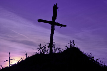 Purple landscape with wooden Cross or crucifix.  Concept for Lent Season, Holy Week, Palm Sunday and Good Friday.
