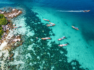 Fototapeta na wymiar Aerial view of the long tail boats on tropical sea satun, Thailand ,Island and coral