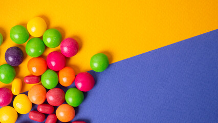 colorful little candies on a colored background