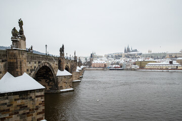 Snow on Charles bridge and Prague castle in winter