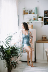 Girl in a robe in the kitchen