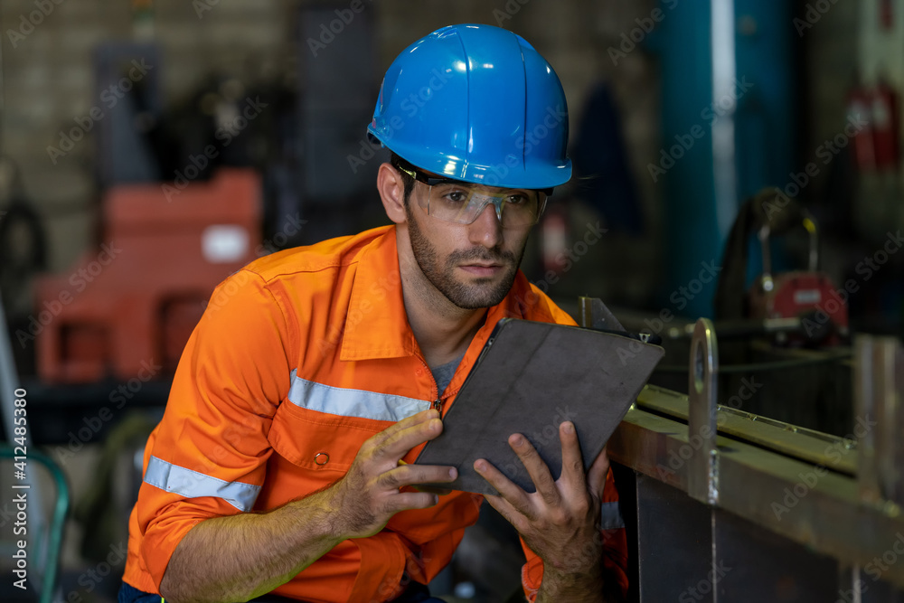 Poster engineer uses tablet checking production process in the industry workplace factory.
