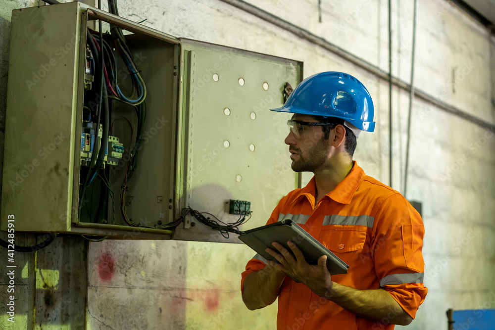 Aufkleber Engineer or factory worker using digital tablet checking inspecting metal component at machine in factory.