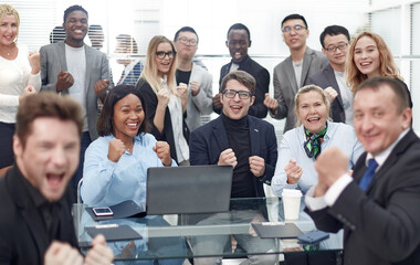 Fototapeta premium multinational working group celebrating together near the desktop.
