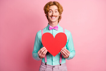 Photo of young happy positive good mood cheerful funky gentleman hold big red heart isolated on pink color background