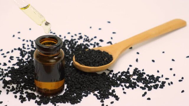 essential oil of black cumin in small bottles. selective focus.