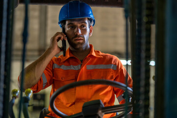 Factory worker are working on a forklift in factory.