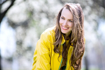 Beautiful woman in spring blooming park