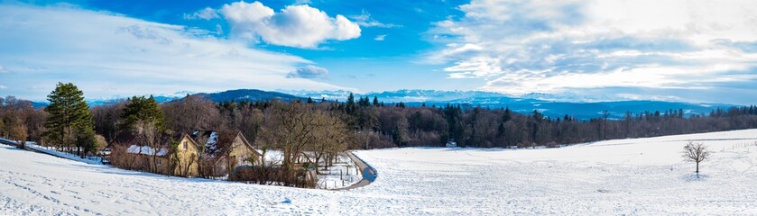 Fototapeta na wymiar panoramic view from the Baldegg restaurant in the canton of Aargau, Baden on a snowy landscape in the background with the Swiss Alps