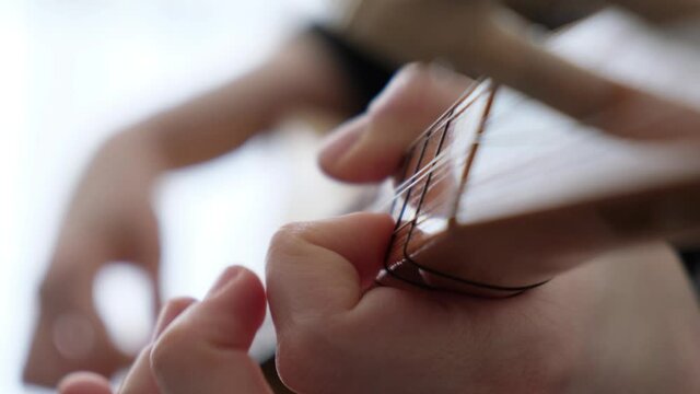 Playing Turkish Traditional String Instrument. Known as Baglama. Close Up Shot of Hands.