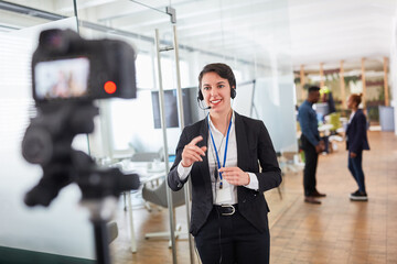 Business woman as a live reporter in front of the video camera