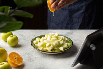 Woman preparing apples sprinkle with lemon juice. Home cooking. Sustainable food