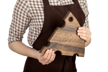 The hands of a culinary man are holding a wooden cutting board.