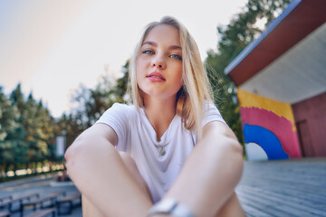 Portrait of a teenage girl on an open stage in the park.