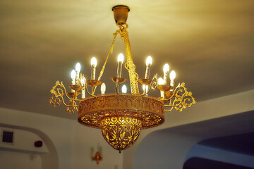 Close-up of a gilded church candelabrum in the chapel. Candelabrum with candles.