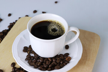 Coffee and Roasted coffee beans on the Wooden tray.