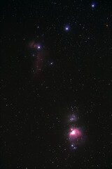Orion constellation with nebulas photographed with long exposure through a telescope.