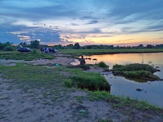 sunset in the river reflects the sky with clouds