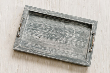 Gray wooden tray with handles. Top view. Close-up. Flat lay.