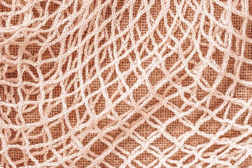 Mesh string bag close-up, reusable bag option, texture, natural background. Recycling, ecology, zero waste concept